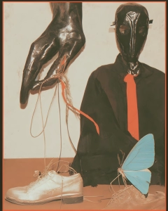 Dark surreal collage with glossy masked forms, a black-clad figure, hanging cords and a pale blue butterfly wing.